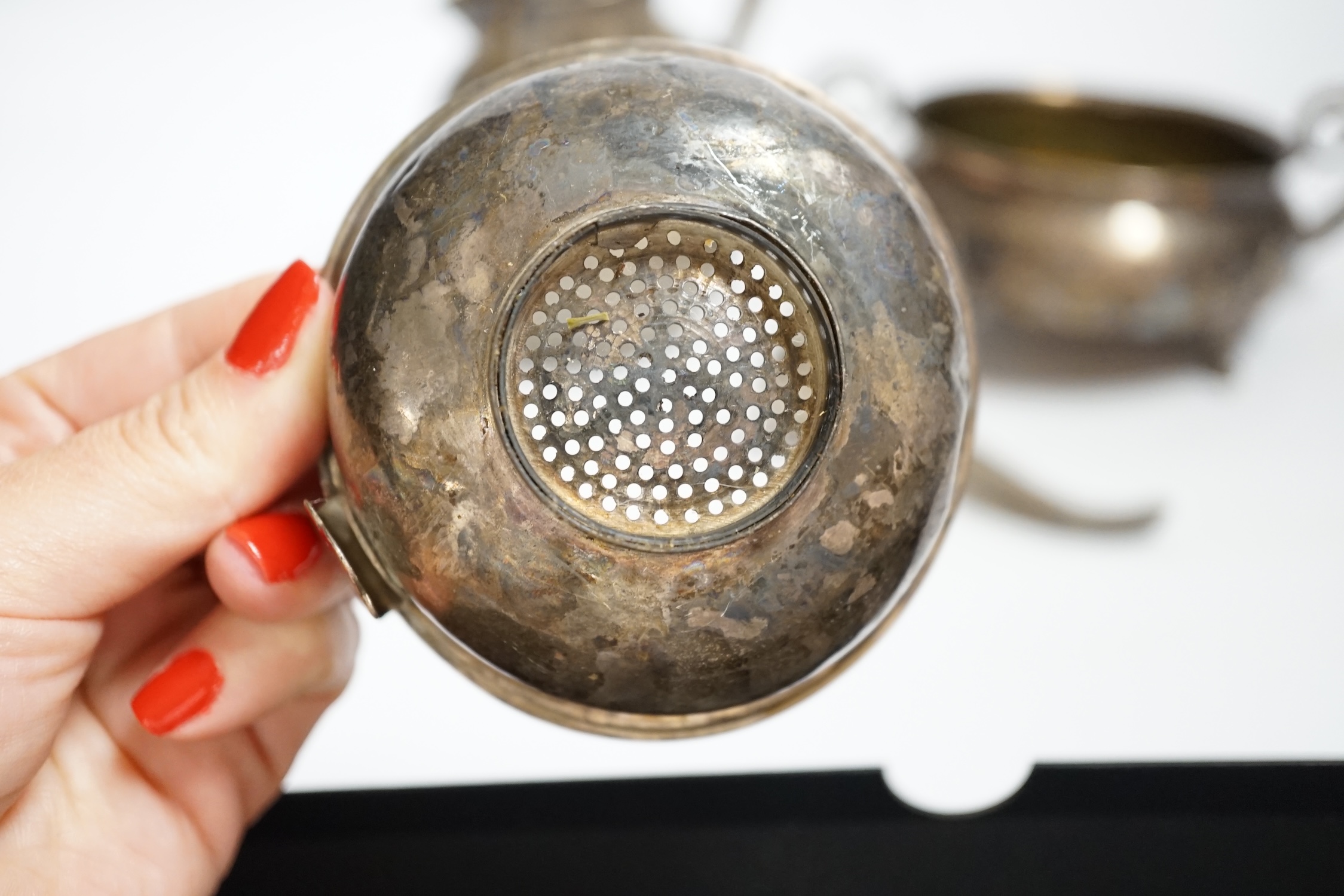 An Edwardian silver 'Guernsey' milk can, Mark Willis & Son, Sheffield, 1904, height 13cm, a George III silver wine funnel by Benjamin Montague? and a continental white metal two handle bowl (a.f.) gross weight 14.3oz.